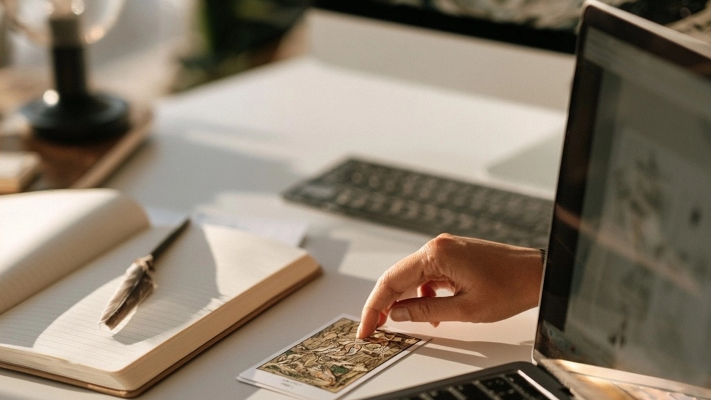 Main comparant une carte, un carnet et un ordinateur